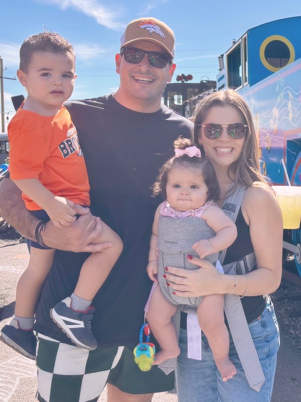Simon with his wife and two kids on a sunny day out