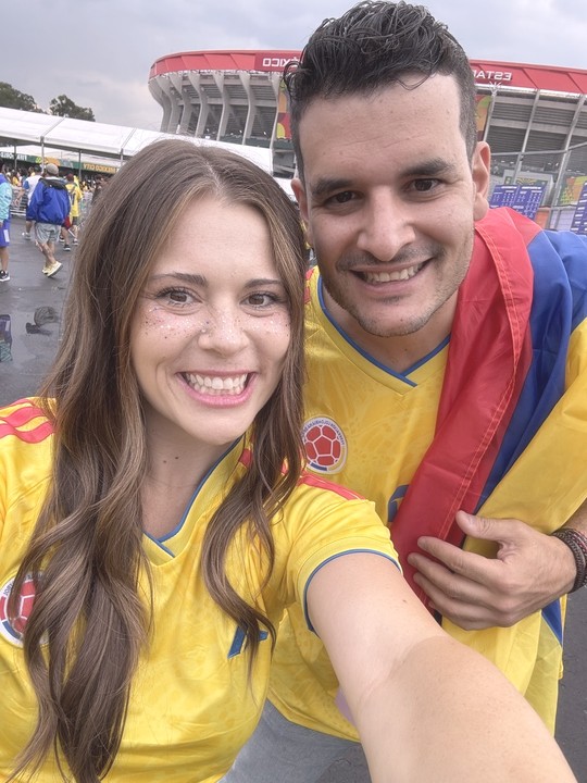 Simon and his wife in Colombia jerseys outside a stadium in Mexico City